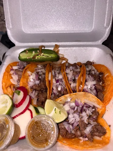 Happy customers enjoying carne asada tacos from Brothers Taquizas Mexican food truck